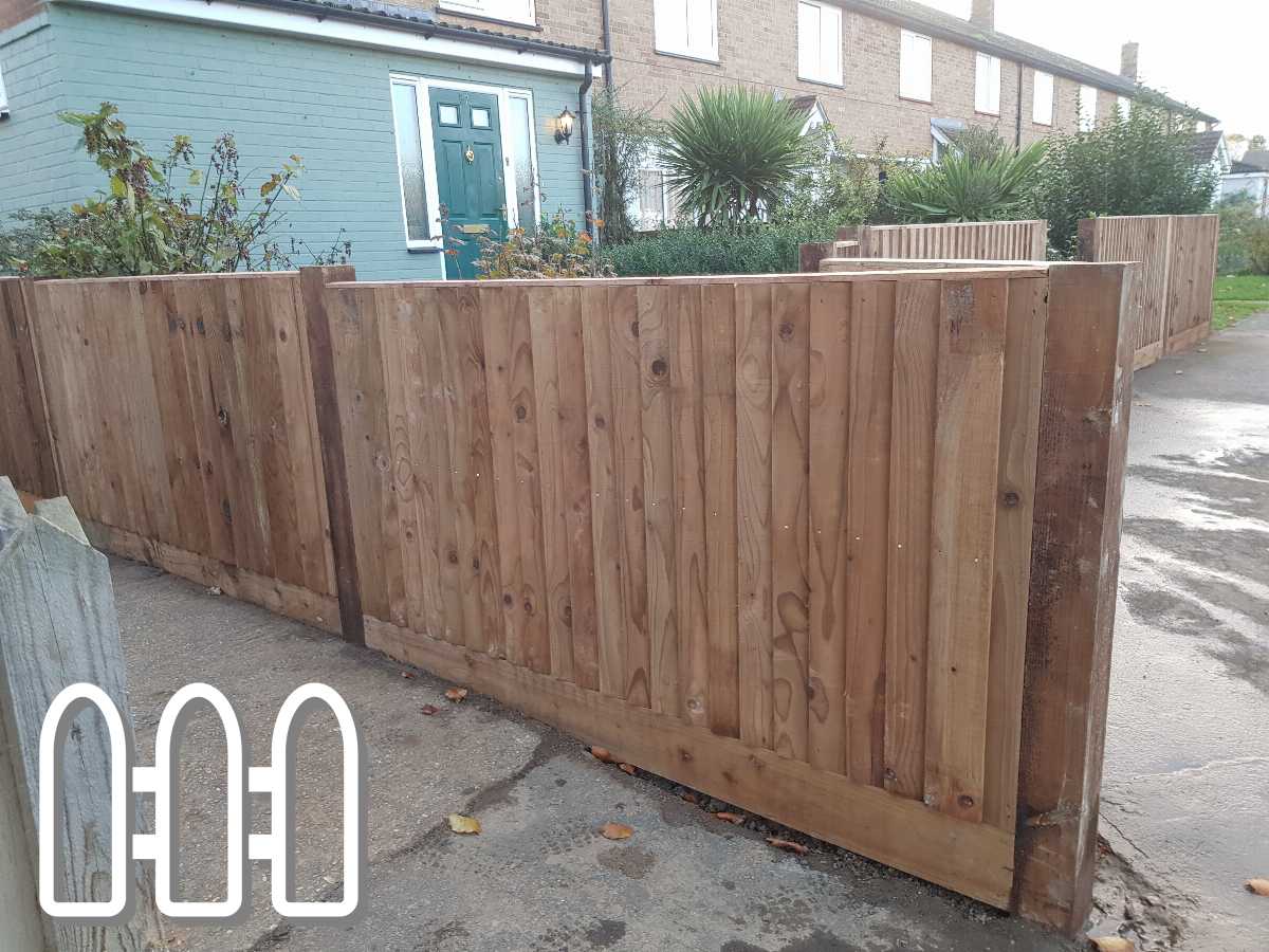 Newly installed wooden fence in front of a residential house, featuring sturdy posts and smooth planks with a natural finish, enhancing the property’s curb appeal.