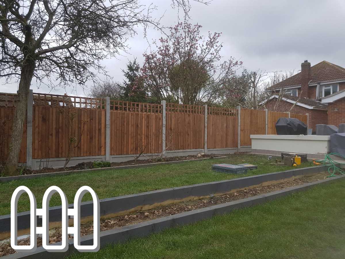 Newly installed wooden privacy fence with lattice top section in a residential backyard, enhancing the garden aesthetics and security