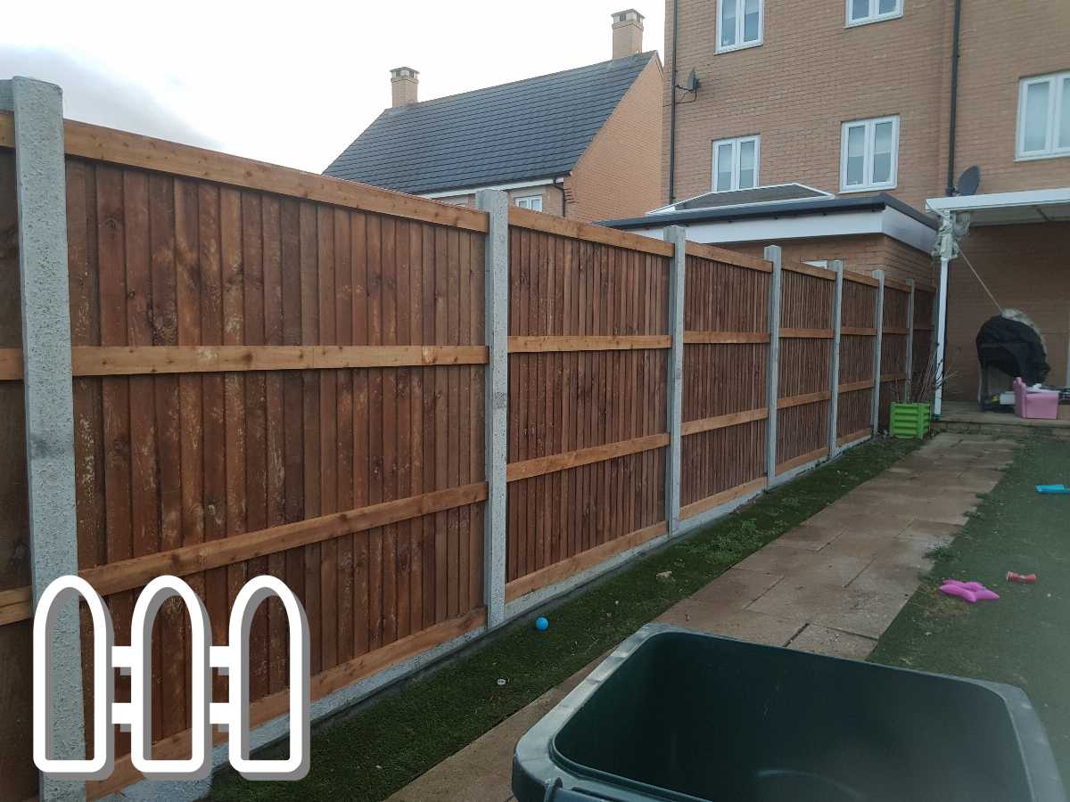 Newly installed wooden fencing in a residential backyard featuring vertical panels and horizontal support beams, complemented by a concrete pathway and a green turf area.