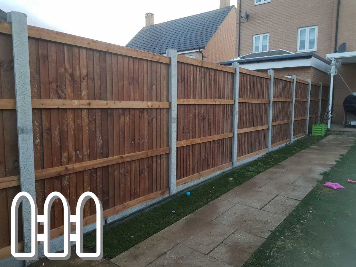 Newly installed wooden fence with concrete posts in a residential backyard during twilight, with a pathway and artificial grass visible.