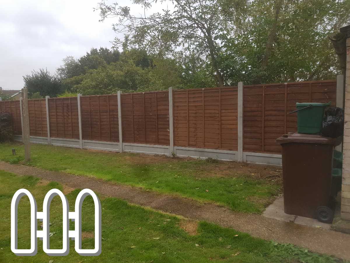 Sturdy brown wooden fence panels installed between grey concrete posts along a residential property, complementing the green and earthy tones of the garden.