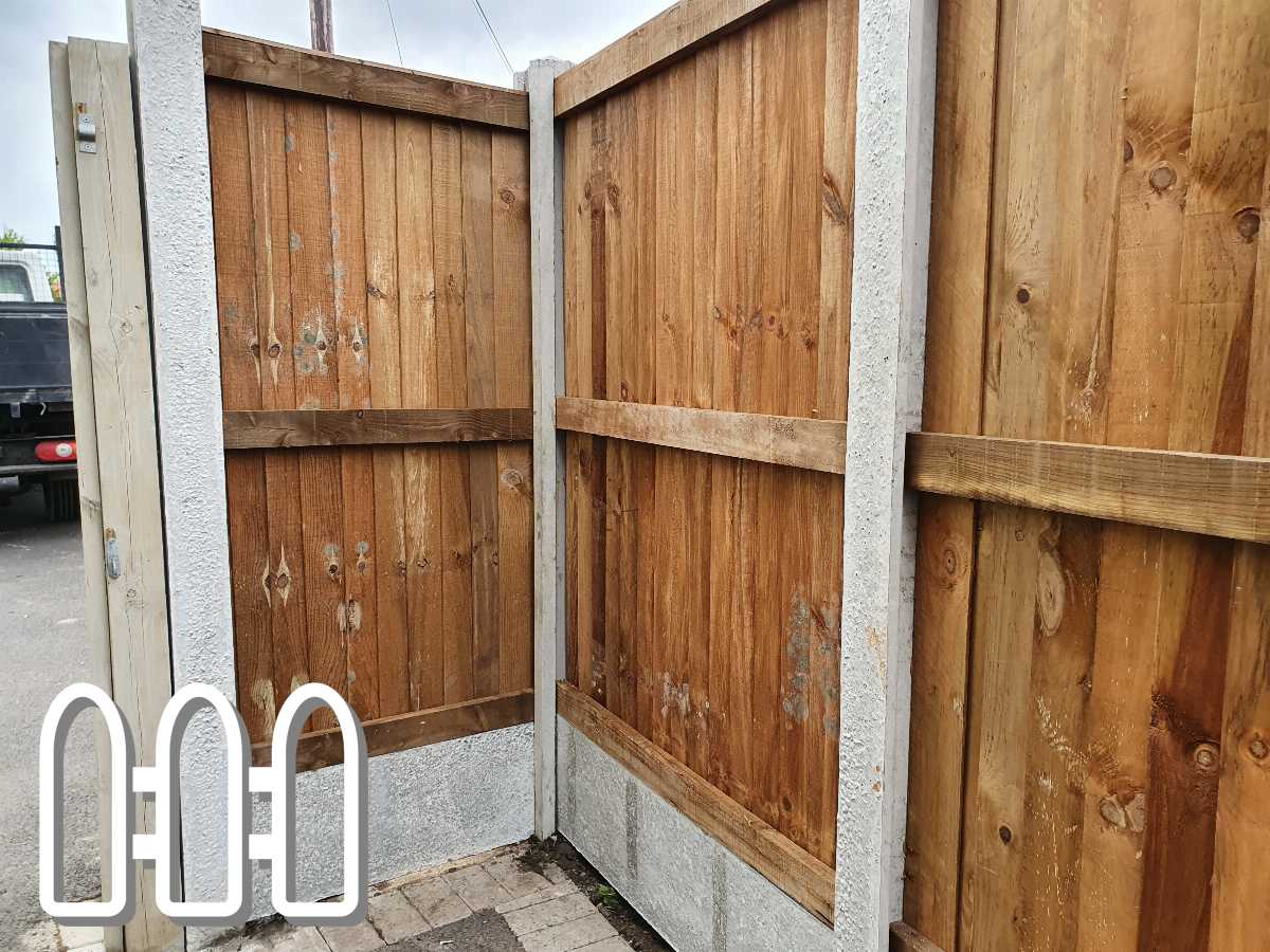 Sturdy wooden fence gate set between concrete posts in a residential driveway, showing a natural wood finish and robust construction