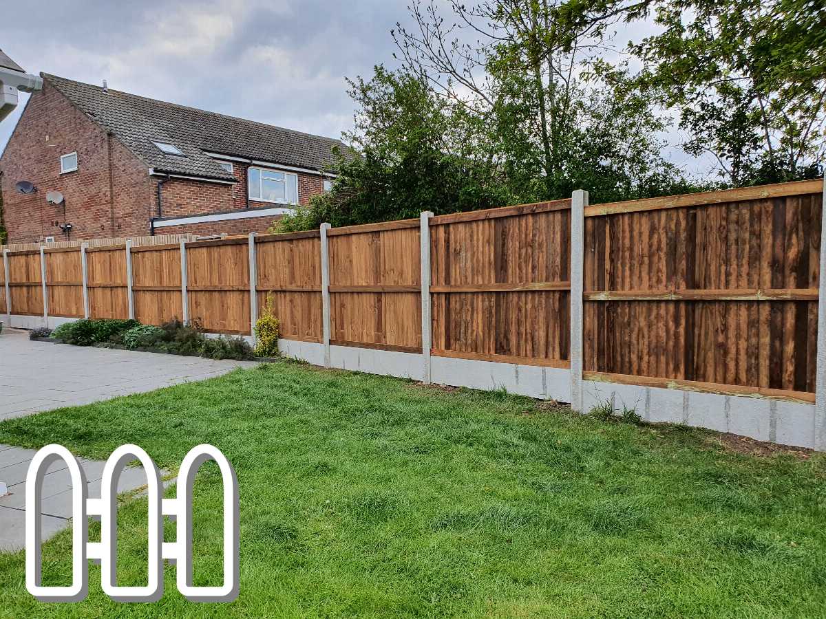 Well-maintained wooden fence panels along a residential property, enhancing privacy and security with a lush green lawn in the foreground