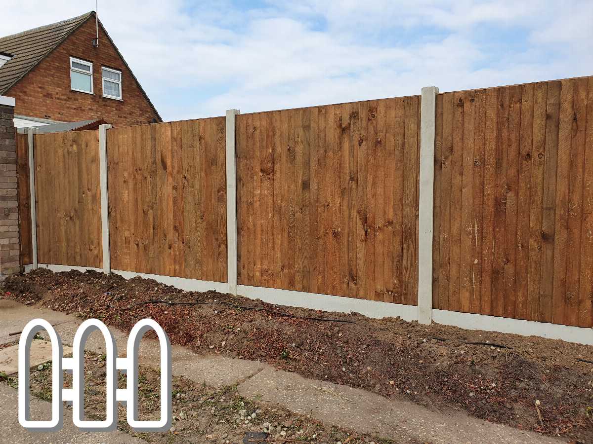 New wooden fence installation in a residential area with concrete posts and gravel boards, featuring richly textured wood panels