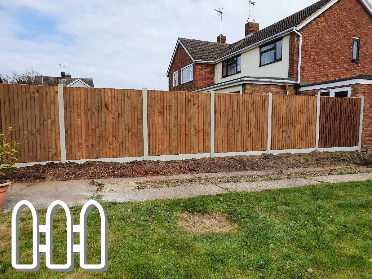 Newly installed wooden fence panels in a residential backyard, providing privacy and enhanced property aesthetics